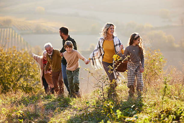 istock Happy extended family having fun while going on a picnic in autumn day. 2212355649