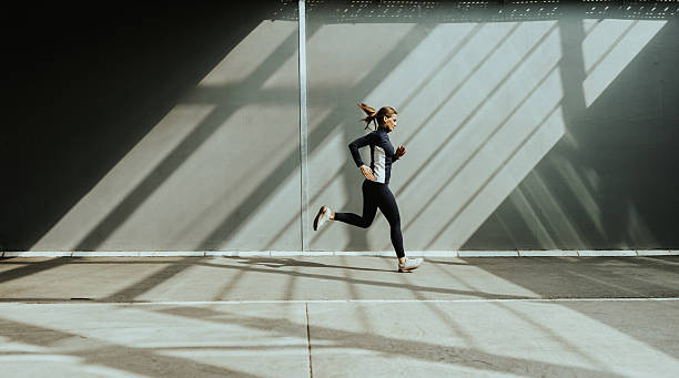 istock Dynamic runner embraces early morning light in an urban environment 2212355908