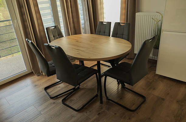istock round light wood table surrounded by 6 brown chairs in a modern classic interior 2212356435