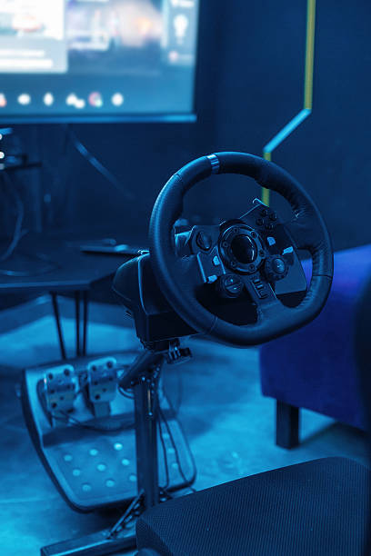 istock Close up view of driving simulator steering wheel and pedals 2212358959