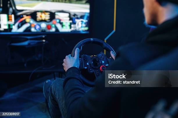 Using Steering Wheel Young Guy Is Playing Racing Game By Using Driving ...