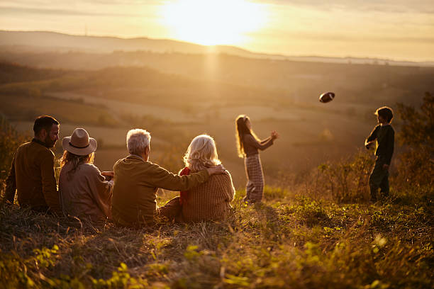 istock Extended family spending an autumn day on a hill at sunset. 2212360962