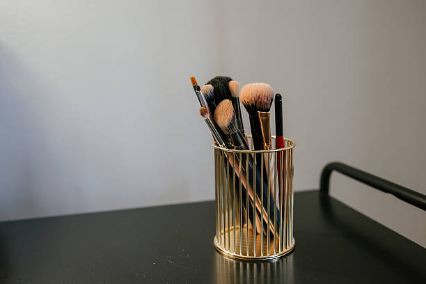 istock Makeup Brushes in Elegant Gold Holder on Display 2212362024