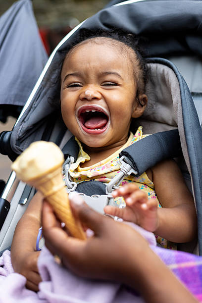 istock Cute Laughing Girl With Ice Cream 2212364125