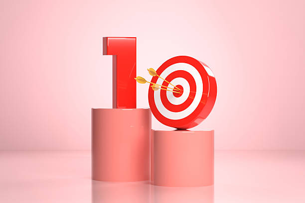 istock Number 1 And Bull's Eye Target On Pink Podium 2212365671