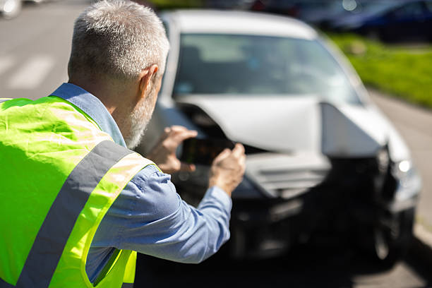 istock Driver documenting vehicle damage with his phone after an accident 2212365887
