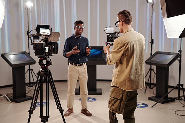 istock Happy African guy talking in front of disabled cameraman 2212368794