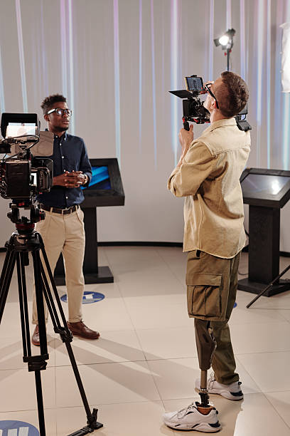 istock Young African man talking in front of video operator 2212368806