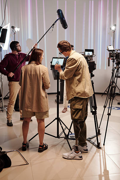 istock Disable cameraman pointing at display of camera during discussion 2212368811