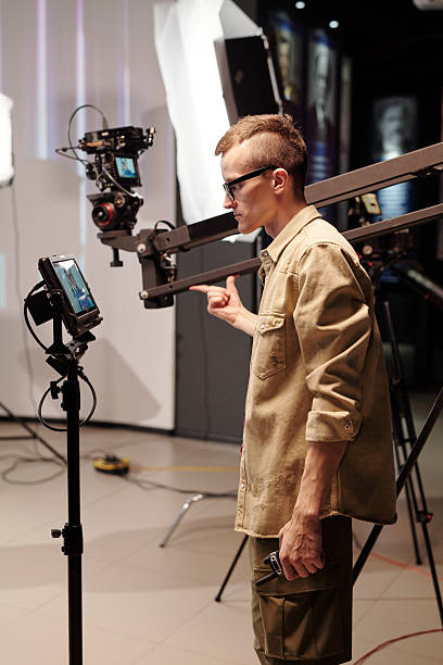 istock Young cameraman looking at display during video shooting 2212368817