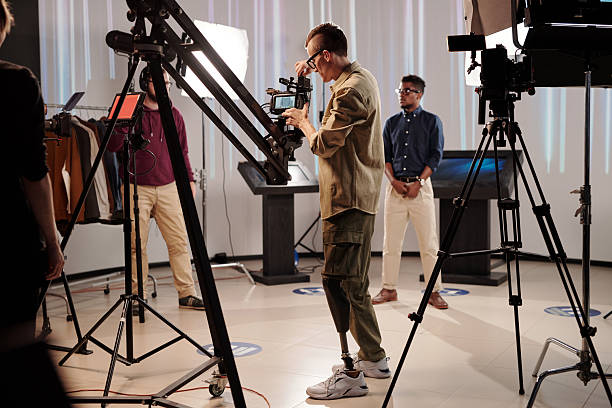 istock Disabled cameraman preparing video shooting equipment 2212368822