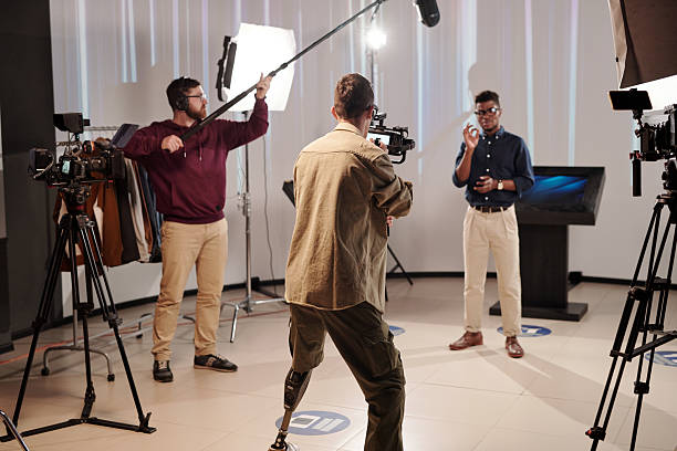 istock Disabled cameraman shooting African guy showing ok gesture 2212368828