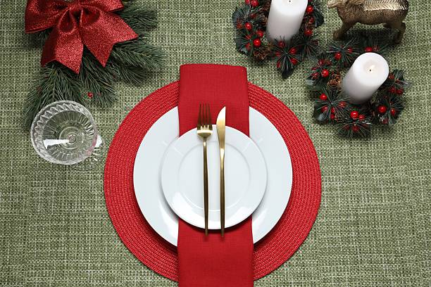 istock Christmas place setting with festive decor on green tablecloth, flat lay 2212370159
