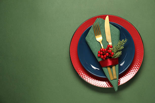 istock Christmas place setting and festive decor on green table, top view. Space for text 2212370181