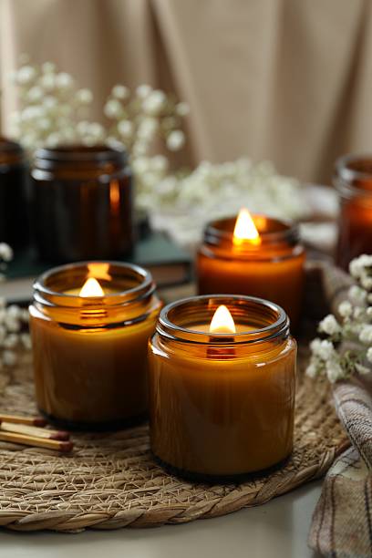 istock Burning candles and beautiful flowers on table 2212370422