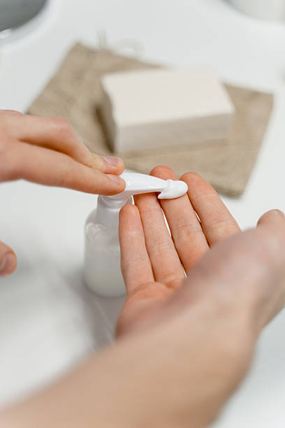 istock A man squeezes a cosmetic product to his hand 2212371740