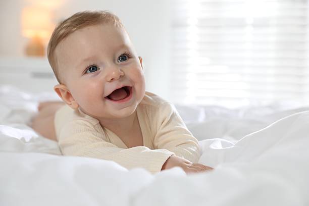 istock Cute little baby on bed at home 2212371977