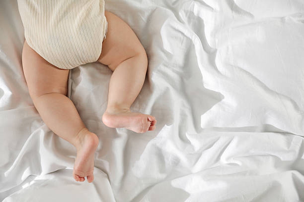 istock Cute little baby on bed indoors, top view. Space for text 2212372064