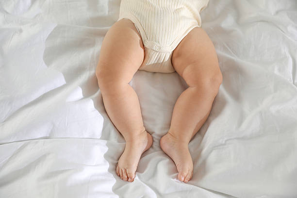 istock Cute little baby on bed indoors, top view 2212372070