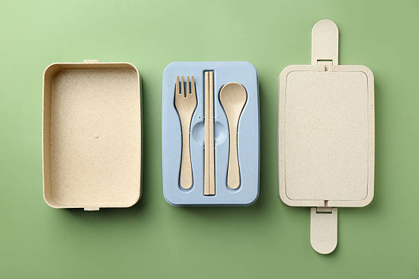 istock Plastic lunch box with cutlery and lid on green background, flat lay 2212372354