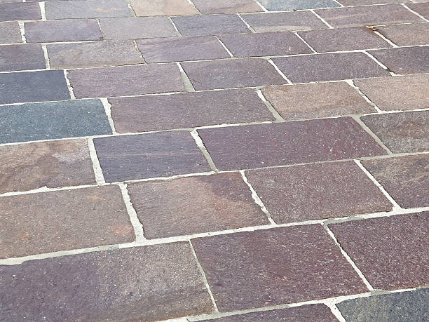 istock Close-up of varied color stone brick pavement with irregular patterns 2212372610