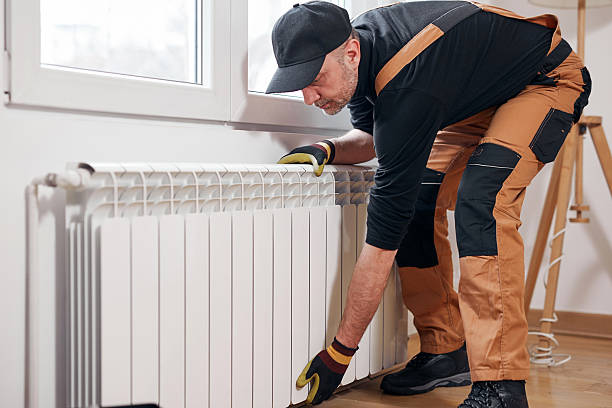 istock Central heating mechanic and handyman fixing home radiator, gas crisis and seasonal issues. 2212372636