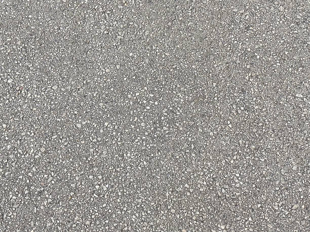 Close-up of textured concrete surface with various pebbles and stones embedded