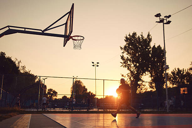 istock Man playing basketball on a public court. 2212373196