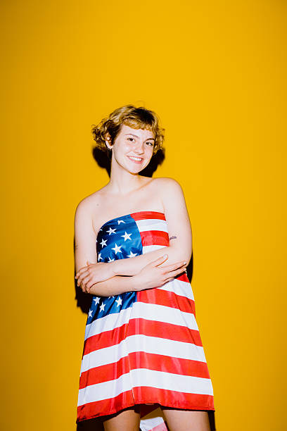 istock Woman flaunts vibrant flag-style outfit on bold backdrop 2212373625