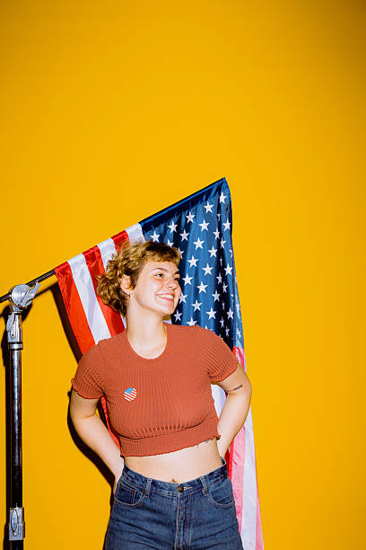 istock Young woman celebrates patriotism with vibrant backdrop 2212374555