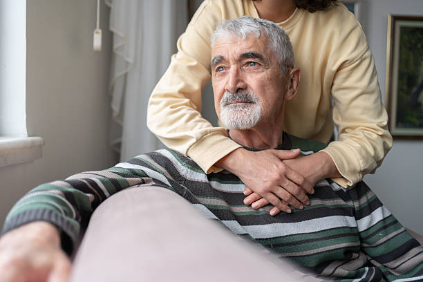 istock Daughter Hugging Senior Father From Behind Holding Hands 2212374790