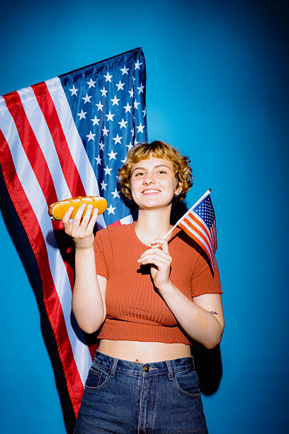 Celebrating summer fun with hot dogs and flags in bright blue