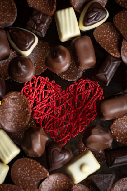 istock Heart-shaped yarn encircled by a creative chocolate arrangement 2212375451