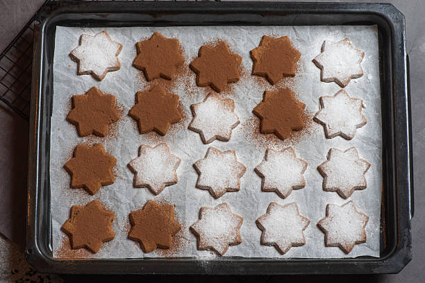 istock Grid cooling rack with star-shaped cookies, some with icing sugar. 2212375670