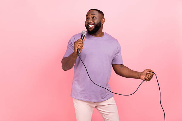 istock Portrait of attractive cheerful guy singing hit pop single free time isolated over pink pastel color background 2212376448