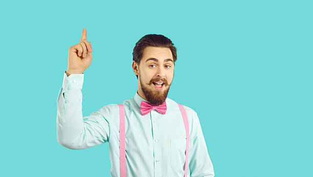 istock Smart stylish handsome man raises his finger up because he came up with brilliant idea. 2212376618