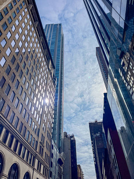 istock Urban Skyscrapers Reaching into a Cloudy Sky in a Bustling City 2212376851