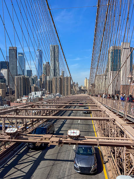 istock Vehicles Crossing Brooklyn Bridge with NYC Skyline 2212376950