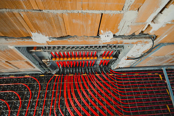 istock Underfloor heating system with manifold and pipes getting installed in a new house 2212378176