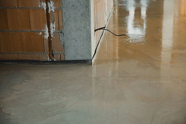 istock Filling up floor with self-leveling mortar over brick wall and concrete beam 2212378196
