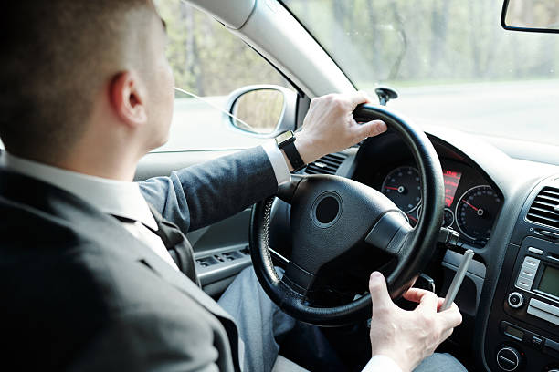 istock Hands of young businessman holding by steer 2212378420