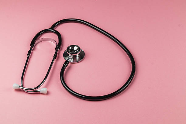 istock Stethoscope placed on a pink background with a gentle curve 2212382155