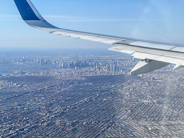 istock Airplane Wing Overlooking New York City Skyline from Above 2212383883