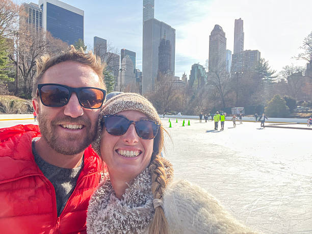 istock Couple Enjoying Ice Skating at Central Park on a Sunny Day 2212383992