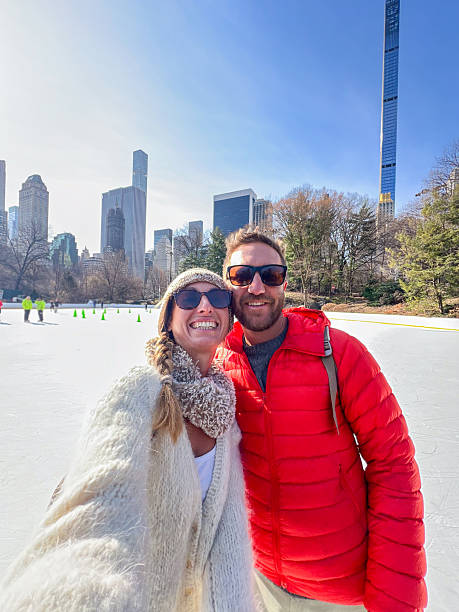 istock Couple Enjoying Ice Skating at Central Park on a Sunny Day 2212383993