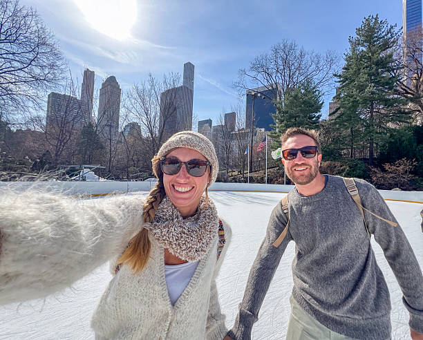 istock Couple Enjoying Ice Skating on a Sunny Day 2212384051