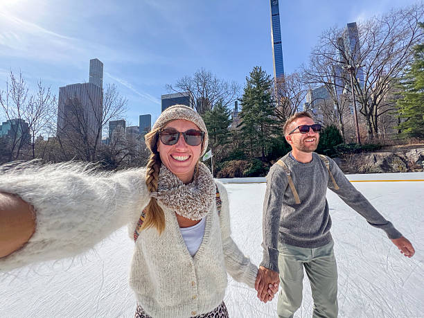 istock Couple Enjoying Ice Skating on a Sunny Day 2212384202