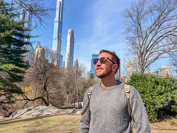 istock Man Enjoying a Sunny Day in Urban Park 2212384260