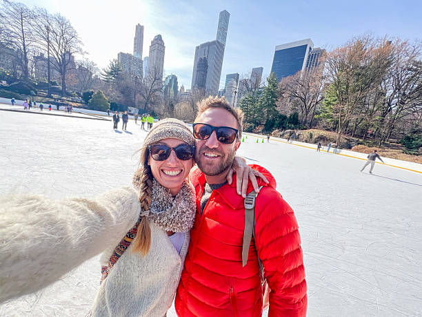 istock Couple Enjoying Ice Skating in Central Park on a Sunny Spring Day 2212384420