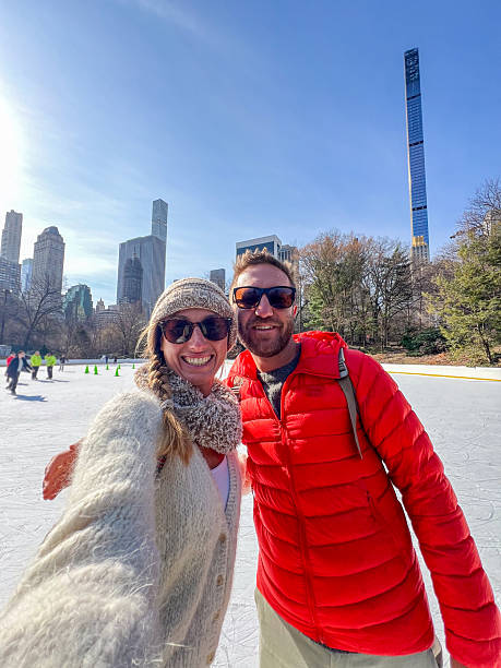 istock Couple Enjoying Ice Skating in Central Park on a Sunny Spring Day 2212384436